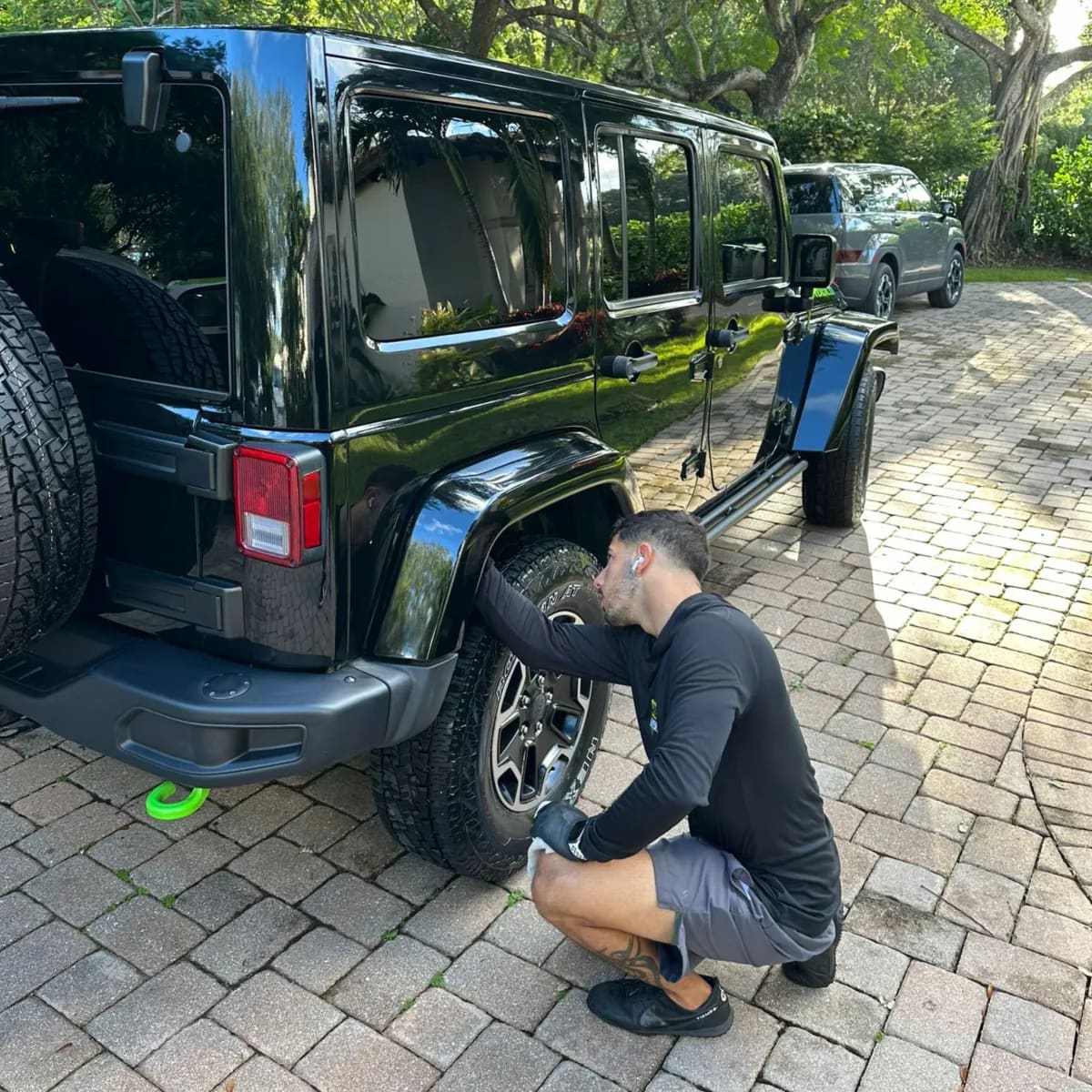 True Wash detailer hand washing a Jeep Wrangler in Miami